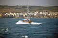 A pleasure boat with lots of sightseers aboard heading back to the sea .