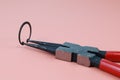 Close up Plier and retaining ring or circlip in working condition Royalty Free Stock Photo