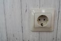 Plug socket outlet on the wooden house wall Royalty Free Stock Photo