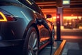 Close-up plugged charging, EV electric car at standalone station Royalty Free Stock Photo