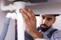 Close-up Of A Plumber Fixing Sink Pipe Royalty Free Stock Photo