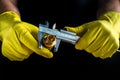 Close-up of a plumber is hands in yellow gloves holding a caliper and a brass fitting. The idea of repairing plumbing equipment