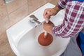 Plumber Using Plunger In Bathroom Sink Royalty Free Stock Photo