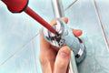 Close-up plumbing hand with screwdriver, adjust angle of shower