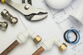 Close up of plumbing paraphernalia on house blueprint Royalty Free Stock Photo