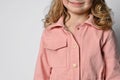 Close-up: a pocket on a denim jacket, overalls, a fragment of a photograph of a girl in a pink jacket with a patch