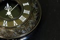 Close up of a pocket watch timepiece. Old clock with ornamental engravings