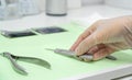 Close-up of the podiatrist`s hand wearing gloves and taking a gouge