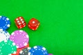 Close-up poker chips and dice on the green baize table with copy space Royalty Free Stock Photo