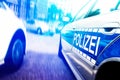 Close-up of police car with flashing emergency lights on motion blurred urban street Royalty Free Stock Photo