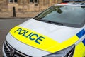 Close-up of a Police car seen parked near the entrance to a college at Cambridge University.