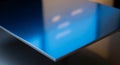 Close up of a polished blue metallic surface with reflections texture Royalty Free Stock Photo