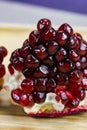 Close up of pomegranate seeds on one part of the pomegranate where there is pomegranate peel. Macro of ripe pomegranate seeds. Royalty Free Stock Photo