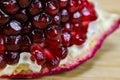 Close up of pomegranate seeds on one part of the pomegranate where there is pomegranate peel. Macro of ripe pomegranate seeds. Royalty Free Stock Photo