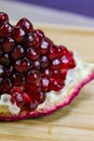 Close up of pomegranate seeds on one part of the pomegranate where there is pomegranate peel. Macro of ripe pomegranate seeds. Royalty Free Stock Photo