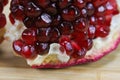 Close up of pomegranate seeds on one part of the pomegranate where there is pomegranate peel. Macro of ripe pomegranate seeds. Royalty Free Stock Photo