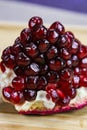 Close up of pomegranate seeds on one part of the pomegranate where there is pomegranate peel. Macro of ripe pomegranate seeds. Royalty Free Stock Photo