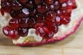 Close up of pomegranate seeds on one part of the pomegranate where there is pomegranate peel. Macro of ripe pomegranate seeds. Royalty Free Stock Photo