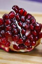 Close up of pomegranate seeds on one part of the pomegranate where there is pomegranate peel. Macro of ripe pomegranate seeds. Royalty Free Stock Photo