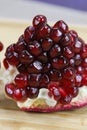 Close up of pomegranate seeds on one part of the pomegranate where there is pomegranate peel. Macro of ripe pomegranate seeds. Royalty Free Stock Photo