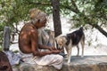 Close up poor man and dog. India