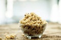 Close up of popular Indian & Asian sweet dish i.e. Malida or churma na ladu or moti chur na ladu in a bowl on brown surface.