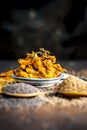 Close up of popular Indian cucumber pickle with all its ingredients including spices and herbs on a wooden surface in dark Gothic Royalty Free Stock Photo