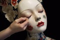 close-up of porcelain doll face being painted Royalty Free Stock Photo