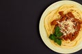 Plate with spaghetti bolognese on the black background Royalty Free Stock Photo