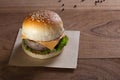 Close up of pork burger with cheese on wood table. Royalty Free Stock Photo