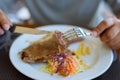 Close-up pork chop steak black pepper with men hand and black pepper sauce, vegetables and french fries Royalty Free Stock Photo