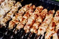 Close up of pork kebabs cooking on a barbecue Royalty Free Stock Photo