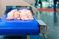 Close up pork or meat sliced on conveyor of automatic and precision slicer machine for industrial food manufacture