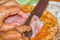 Close up Pork placed on the chopping block is cut by a knife Royalty Free Stock Photo