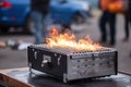 close-up of portable grill, with flames and smoke visible