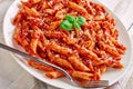 Close-up of a portion of classic italian penne arrabiata