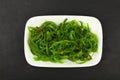 Close up portion of green wakame seaweed salad