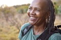 Close Up Portrait Of Active Senior Woman With Backpack Hiking In Countryside 