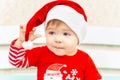 Close up portrait of adorable christmas child in a red hat. Christmas little baby boy. Xmas card with cute toddler kid Royalty Free Stock Photo