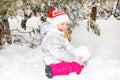 Close up portrait of adorable happy little girl grinning happily at the camera on a sunny winter`s day Royalty Free Stock Photo