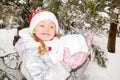 Close up portrait of adorable happy little girl grinning happily at the camera on a sunny winter`s day Royalty Free Stock Photo