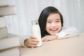 Close up portrait of adorable little asian girl drinking glass o