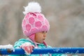 Close-up portrait of adorable little girl wearing knitted pink hat outdoors Royalty Free Stock Photo