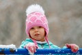 Close-up portrait of adorable little girl wearing knitted pink hat outdoors Royalty Free Stock Photo