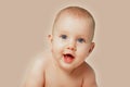 Close-up portrait of adorable newborn baby smiling on isolated beige background. People Lifestyle Family Kids Emotions concept. Royalty Free Stock Photo