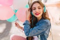 Close-up portrait of adorable smiling girl wearing denim jacket having fun at the birthday party. Stylish young woman Royalty Free Stock Photo