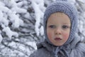 Close-up portrait of adorable toddler against winter background. Copy space Royalty Free Stock Photo