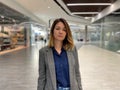 Close up portrait of adult Caucasian woman with serious face expression standing in shopping mall and looking at camera Royalty Free Stock Photo