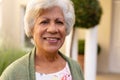 Close-up portrait of african american senior woman smiling while standing outdoors Royalty Free Stock Photo