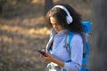 Close-up portrait of an african american woman, who lost in forest. Lost in forest and using GPS app in mobile phone Royalty Free Stock Photo